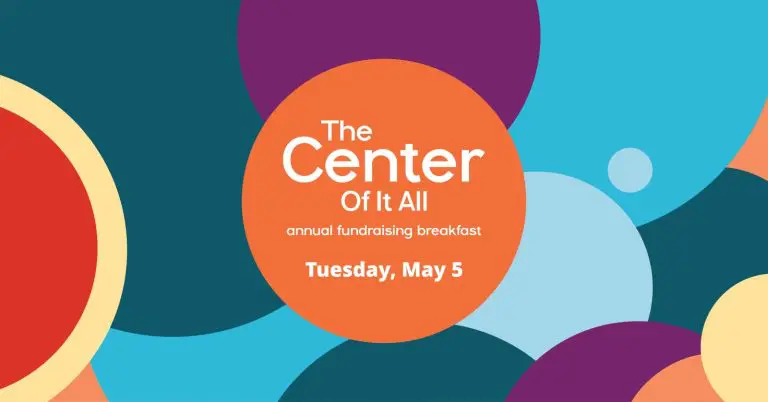 Colorful circles background with orange circle containing text: "The Center Of It All, Annual Fundraising Breakfast, Tuesday, May 5.