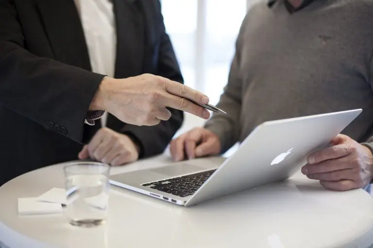 Two people in business attire stand