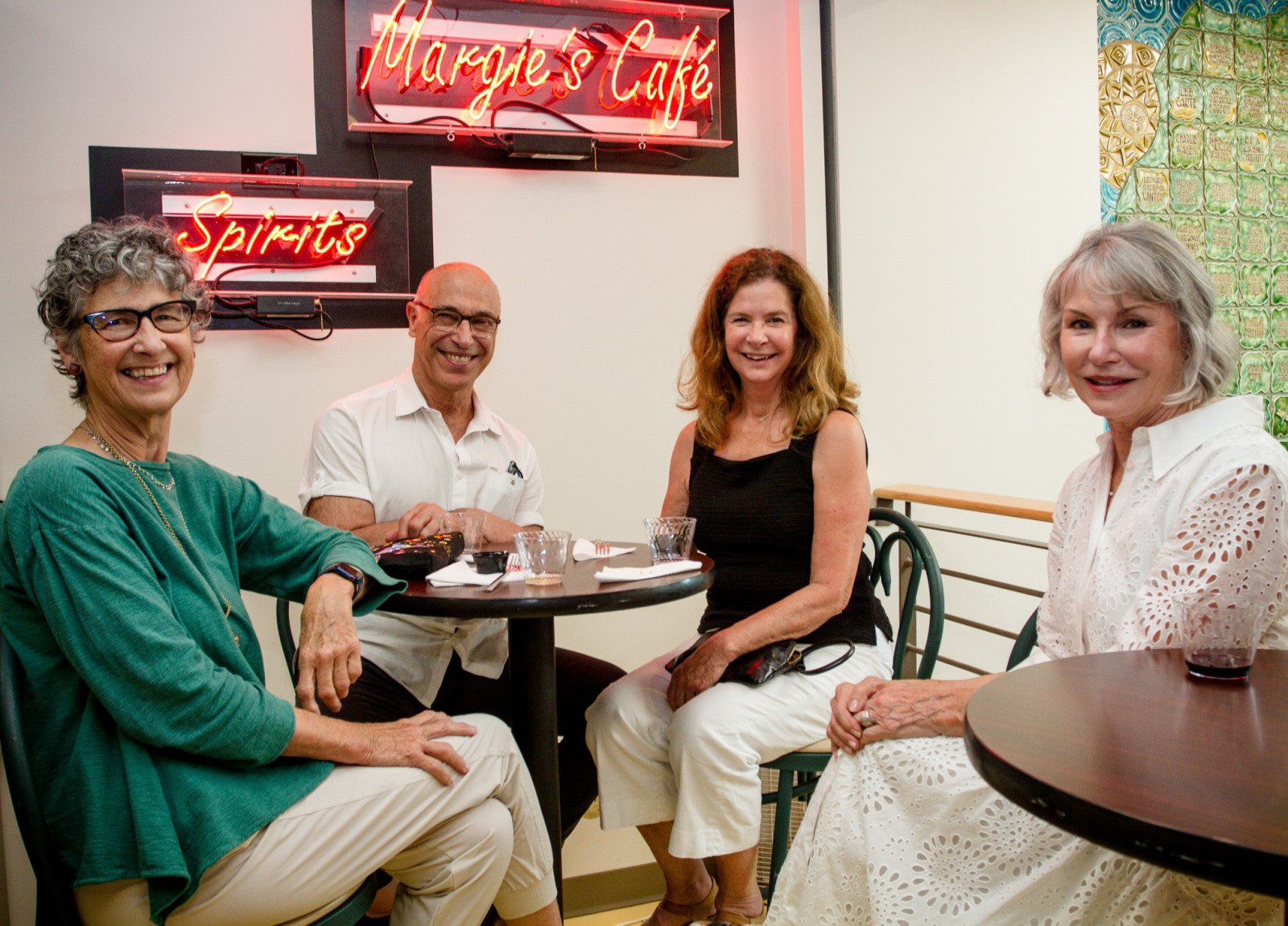Four members at the Center sitting at Margie's Cafe.