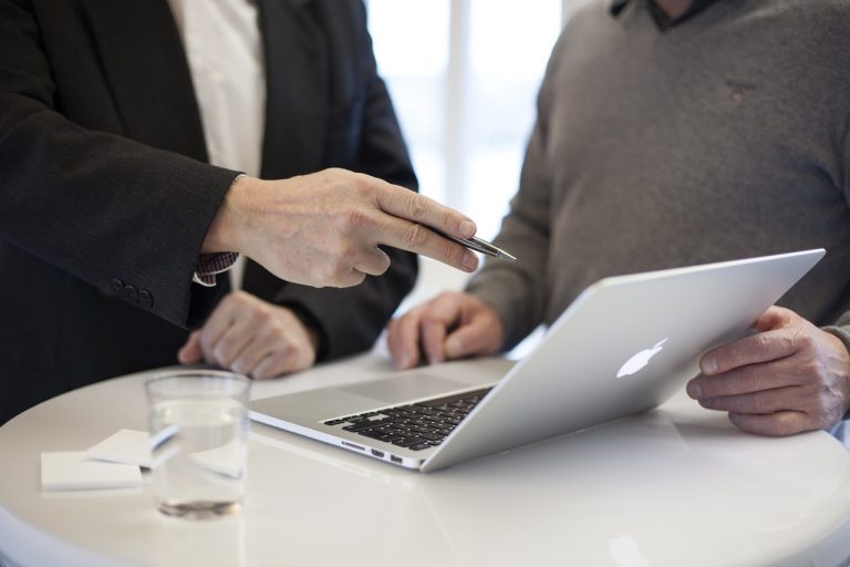 Two people in business attire stand