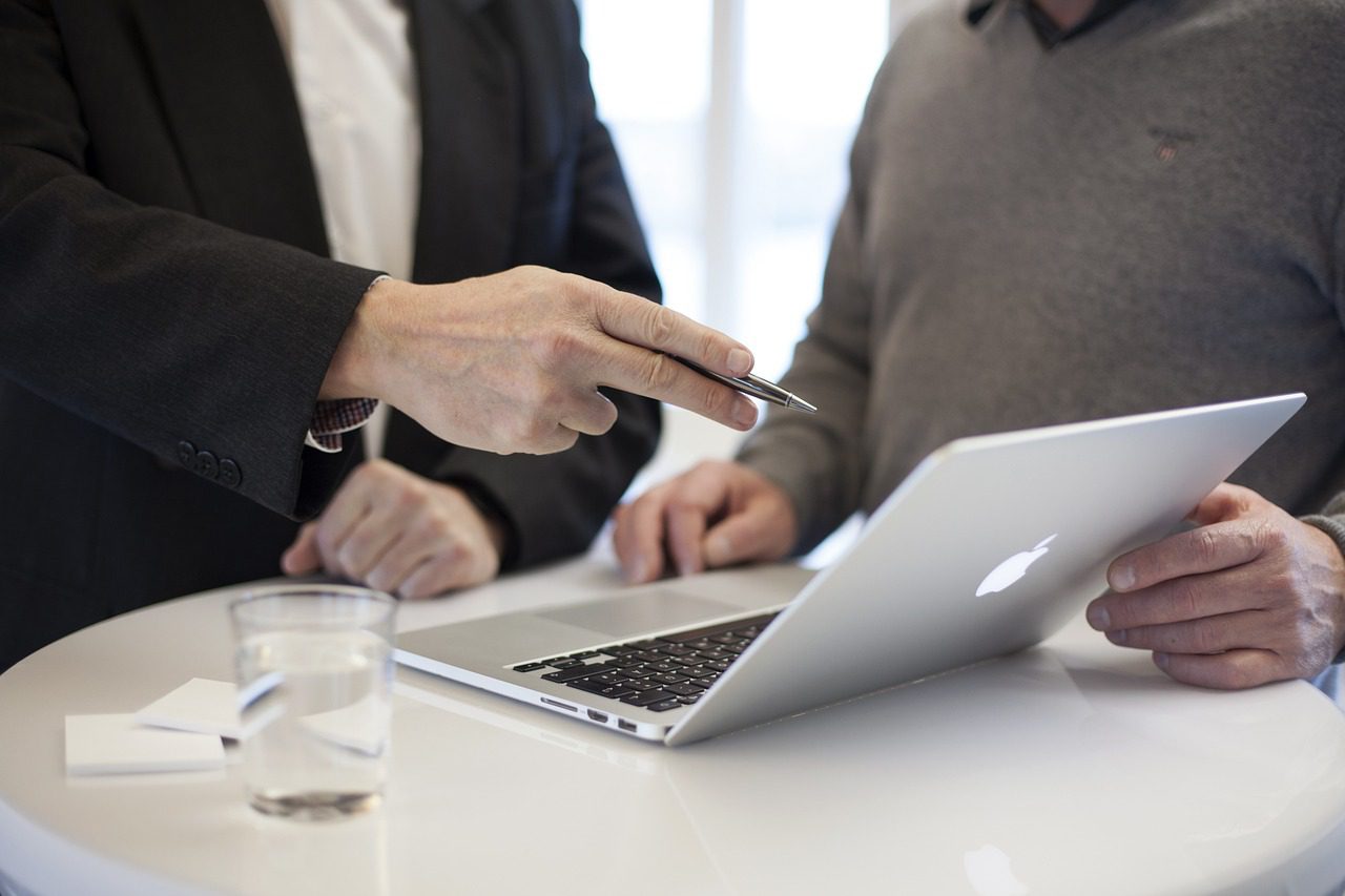 Two people in business attire stand