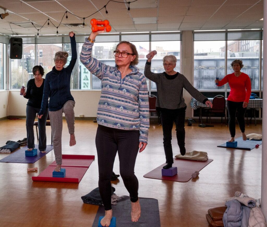 A group of adults participate in a exercise class at The Center