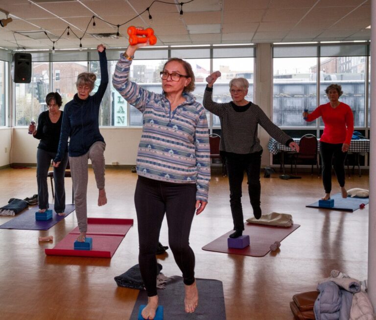 A group of adults participate in a exercise class at The Center