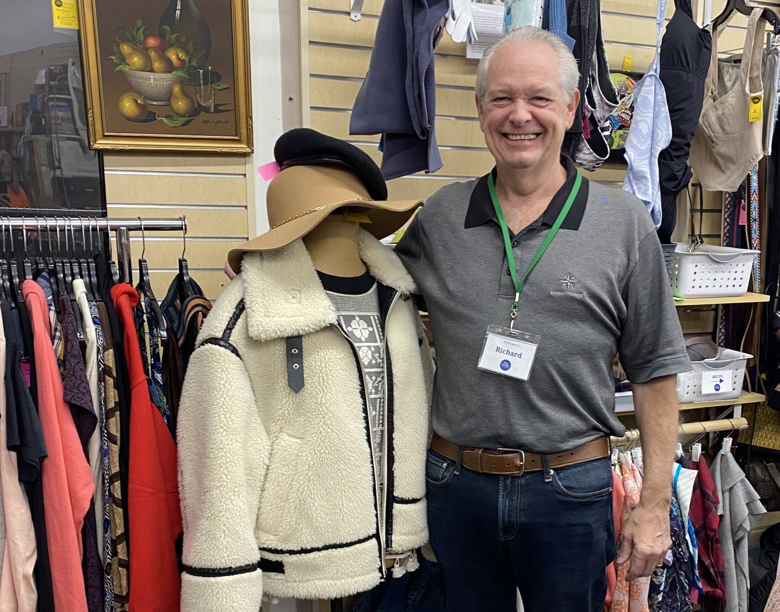 Volunteer in the Thrift Store is posing with an outfit