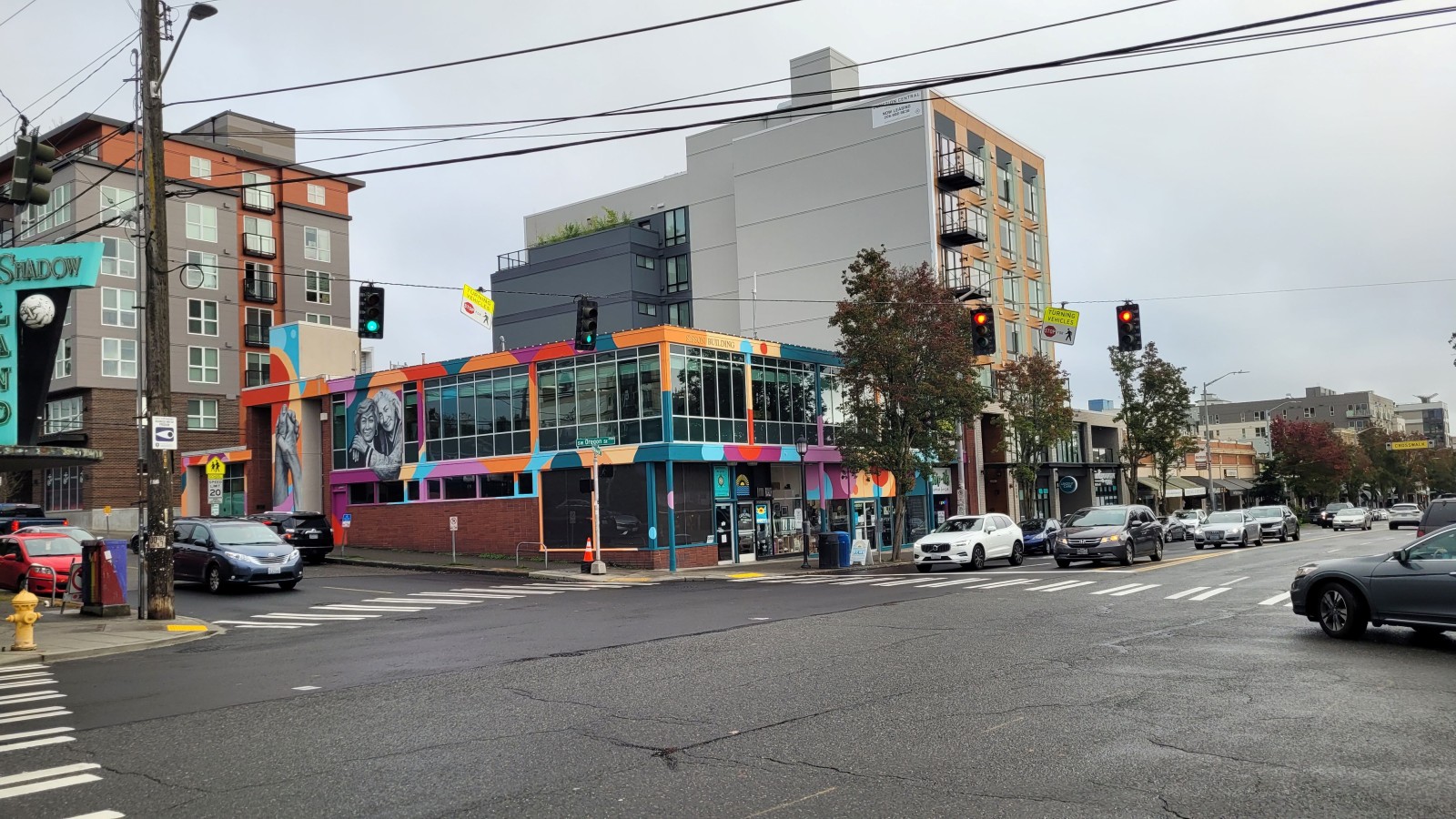 Wide shot of the West Seattle Junction with cars and crosswalks. The Center for Active Living is in the middle.