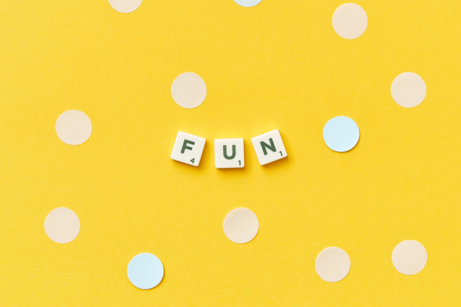 Scrabble tiles spelling “FUN”