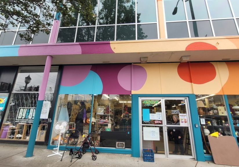 Exterior of Center thrift store with colorful circular patterns above large windows