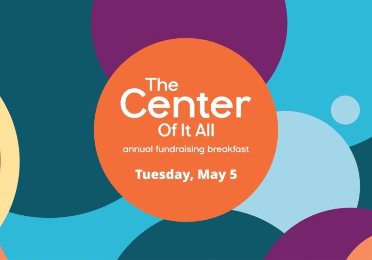 Colorful circles background with orange circle containing text: "The Center Of It All, Annual Fundraising Breakfast, Tuesday, May 5.