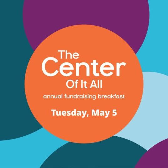 Colorful circles background with orange circle containing text: "The Center Of It All, Annual Fundraising Breakfast, Tuesday, May 5.