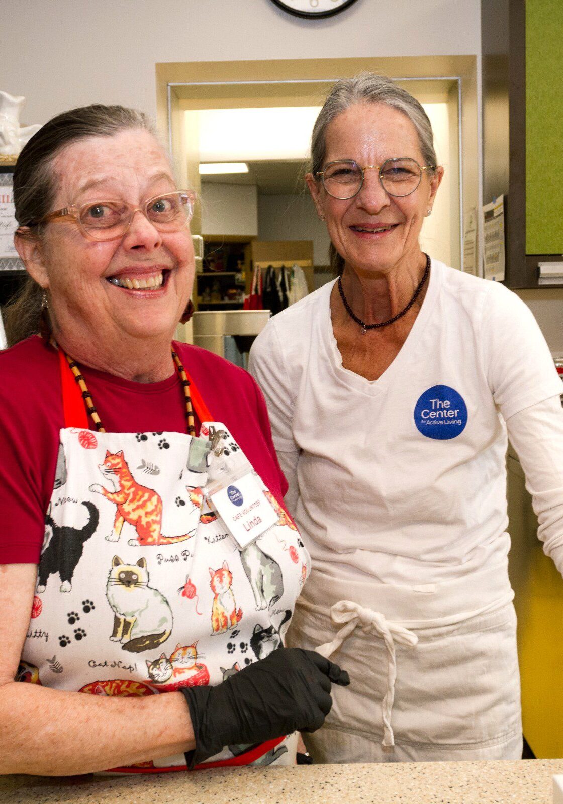 Two volunteers at the Margie's Cafe counter
