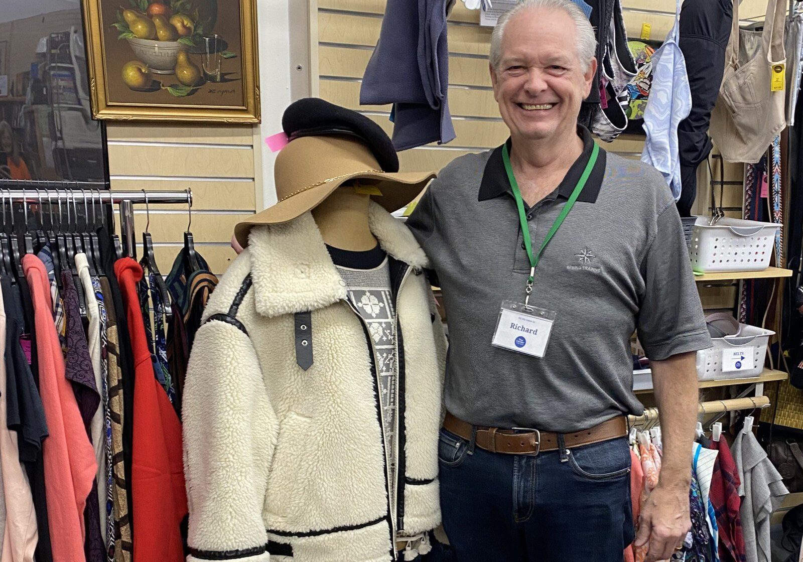 Volunteer in the Thrift Store is posing with an outfit