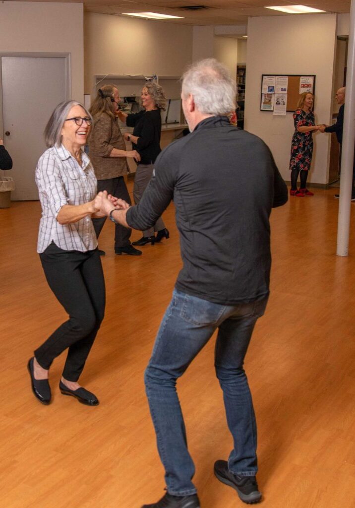 Two Center members participating in swing dance class